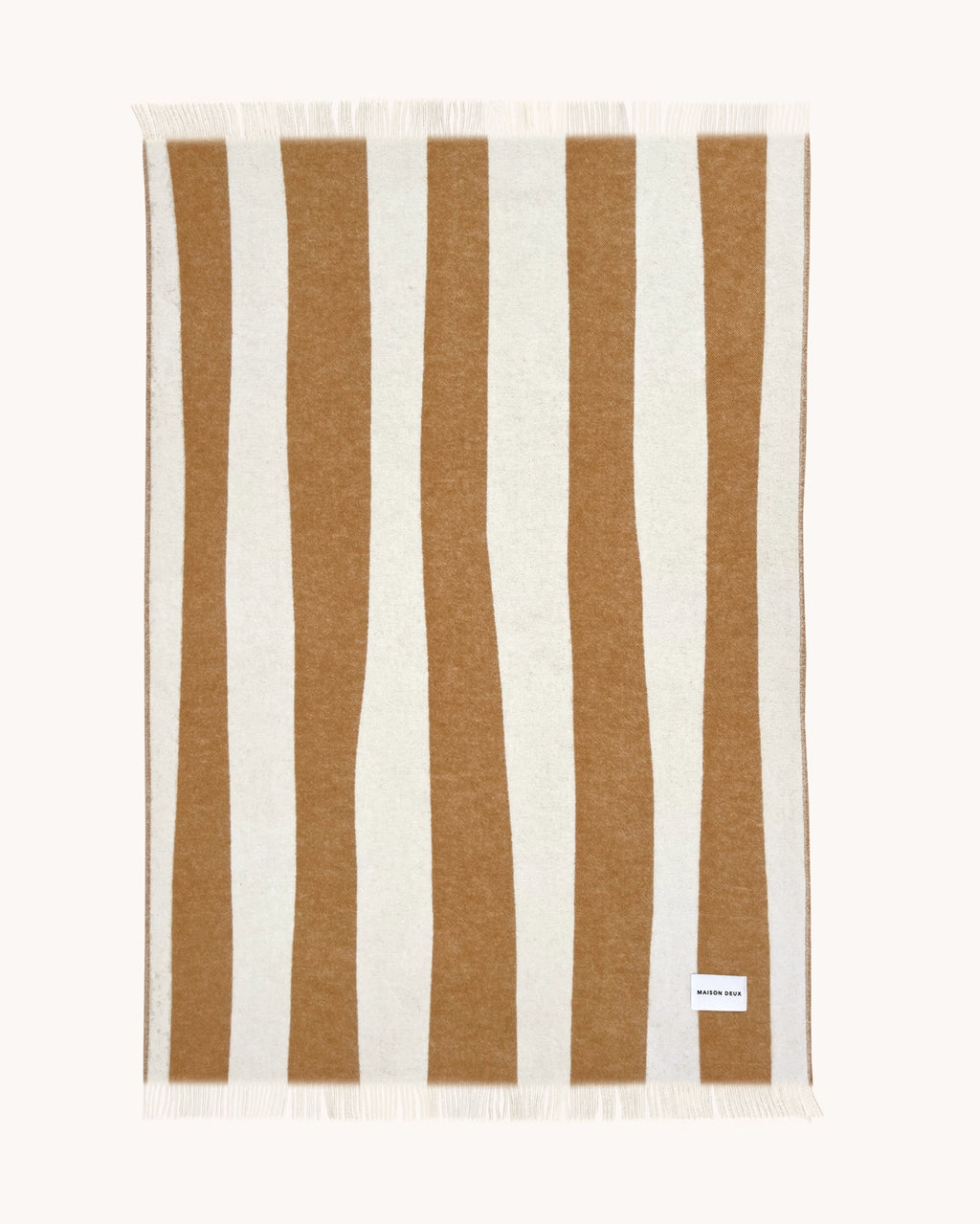 Terracotta and white striped wool throw shown flat

