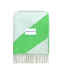 Apple green and white swirl wool blanket folded with fringe detail

