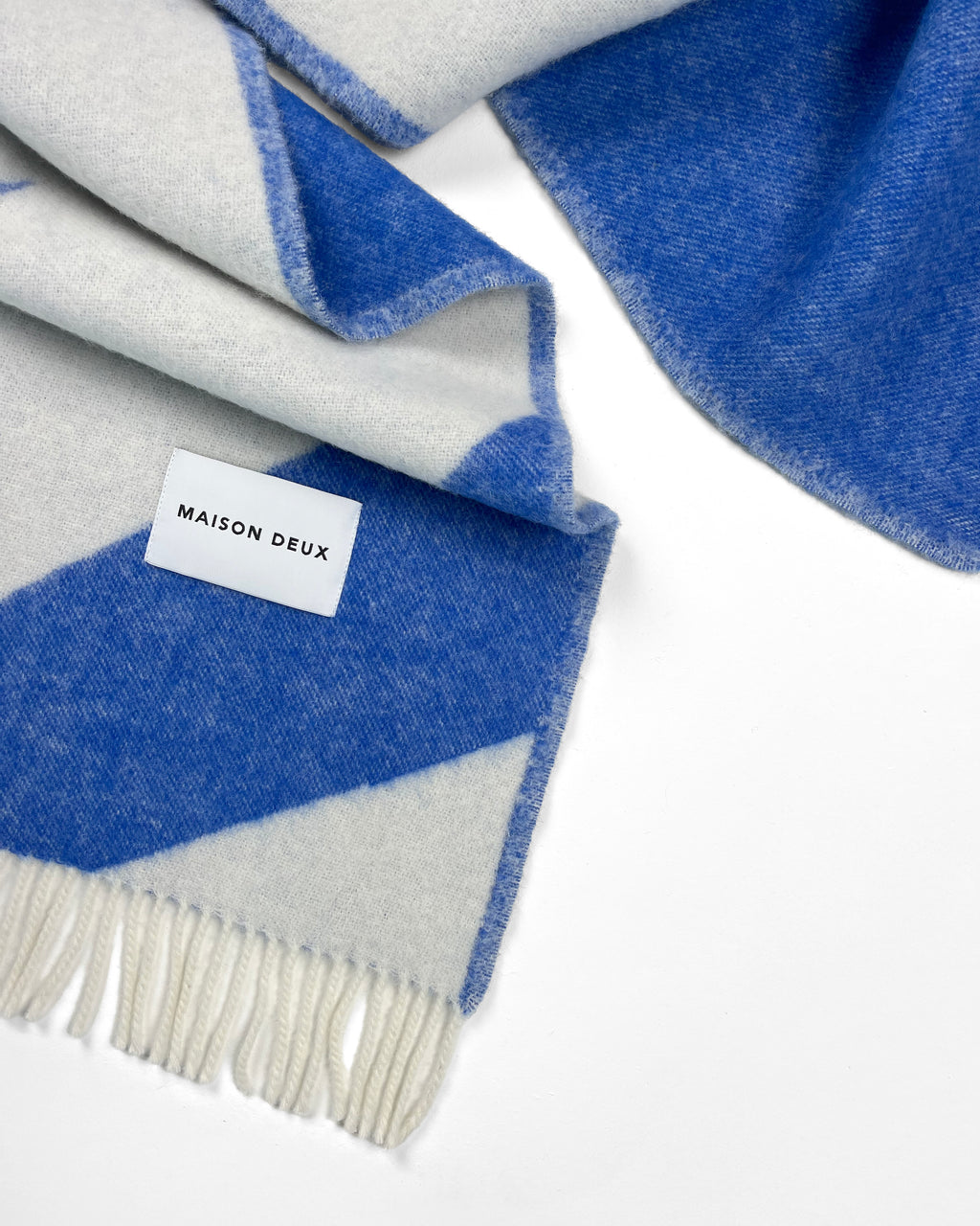 Close-up of folded cobalt blue and white swirl wool blanket
