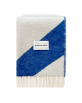 Cobalt blue and white swirl wool blanket folded with fringe detail
