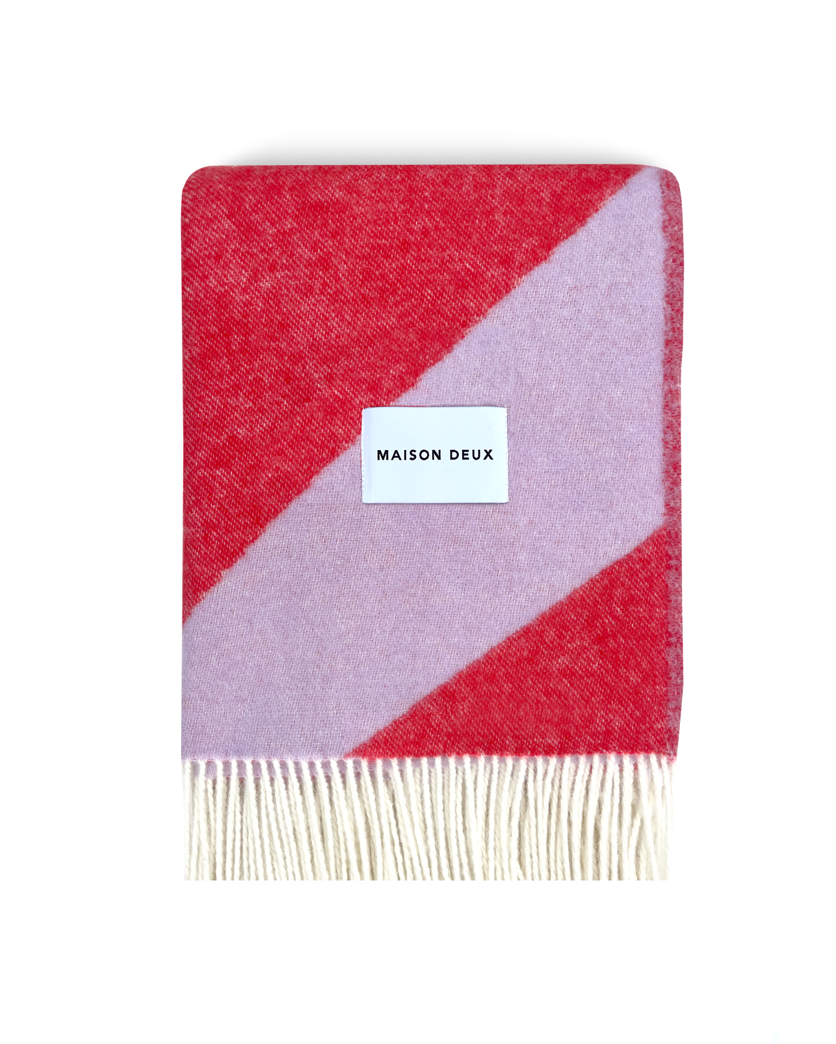 Lilac and scarlet swirl wool blanket folded with fringe detail
