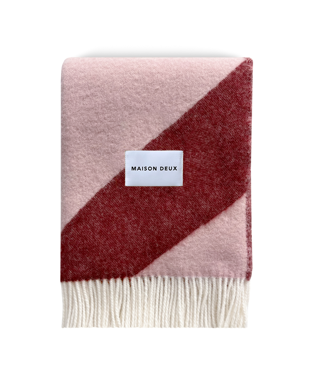 Pink and bordeaux swirl wool blanket folded with fringe detail