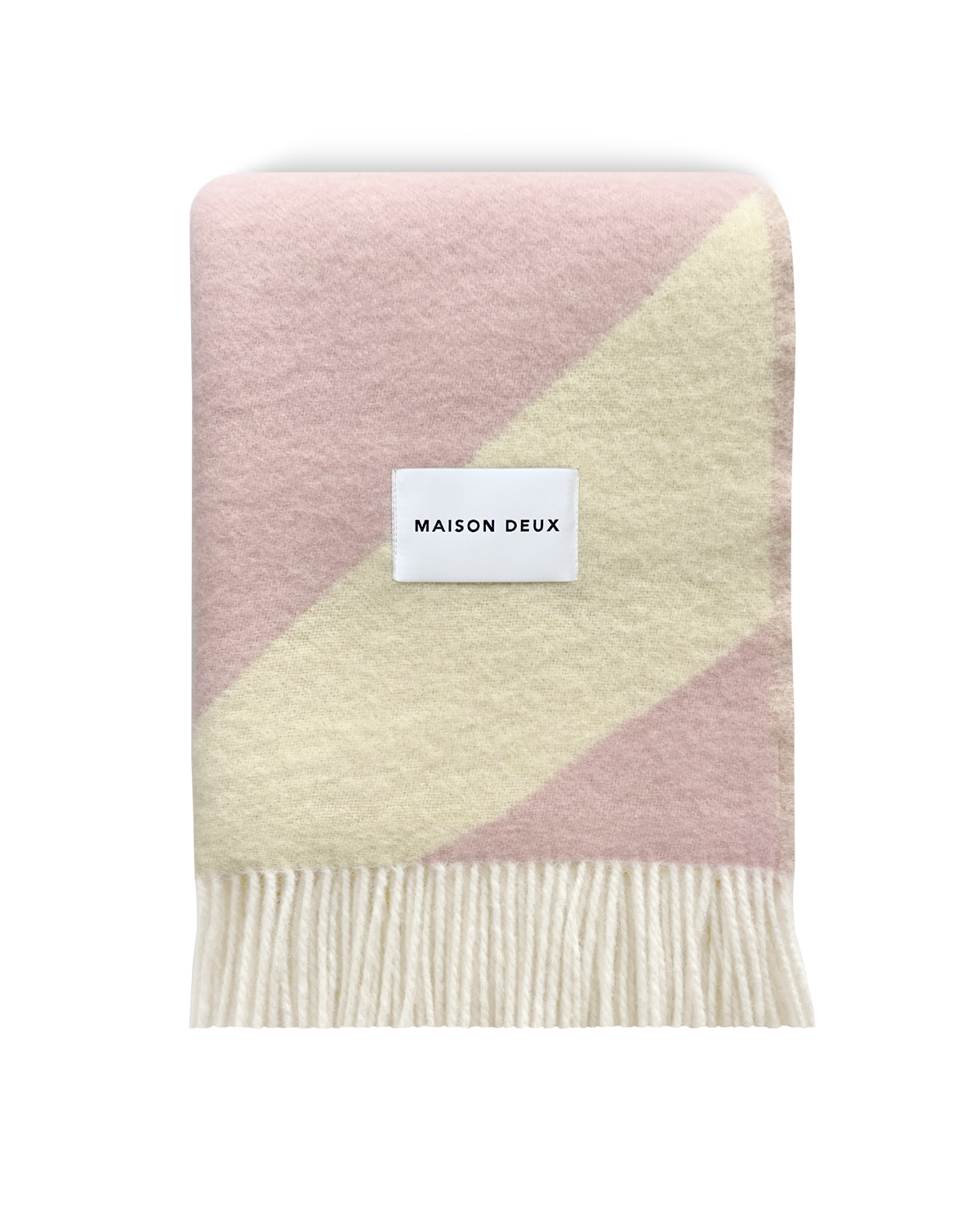 Pink and butter yellow swirl wool blanket folded with fringe detail
