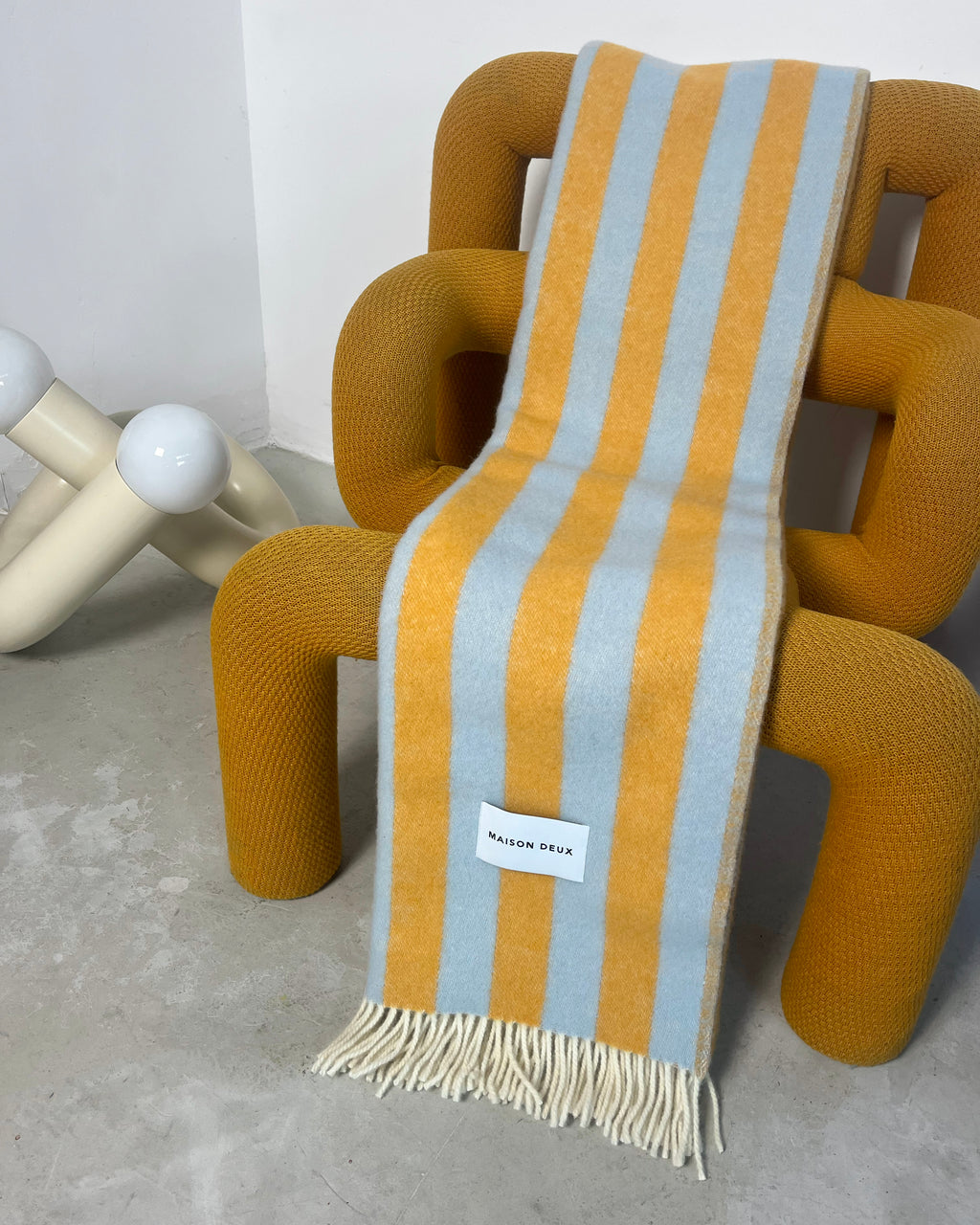 Blue and honey yellow striped wool throw draped over chair