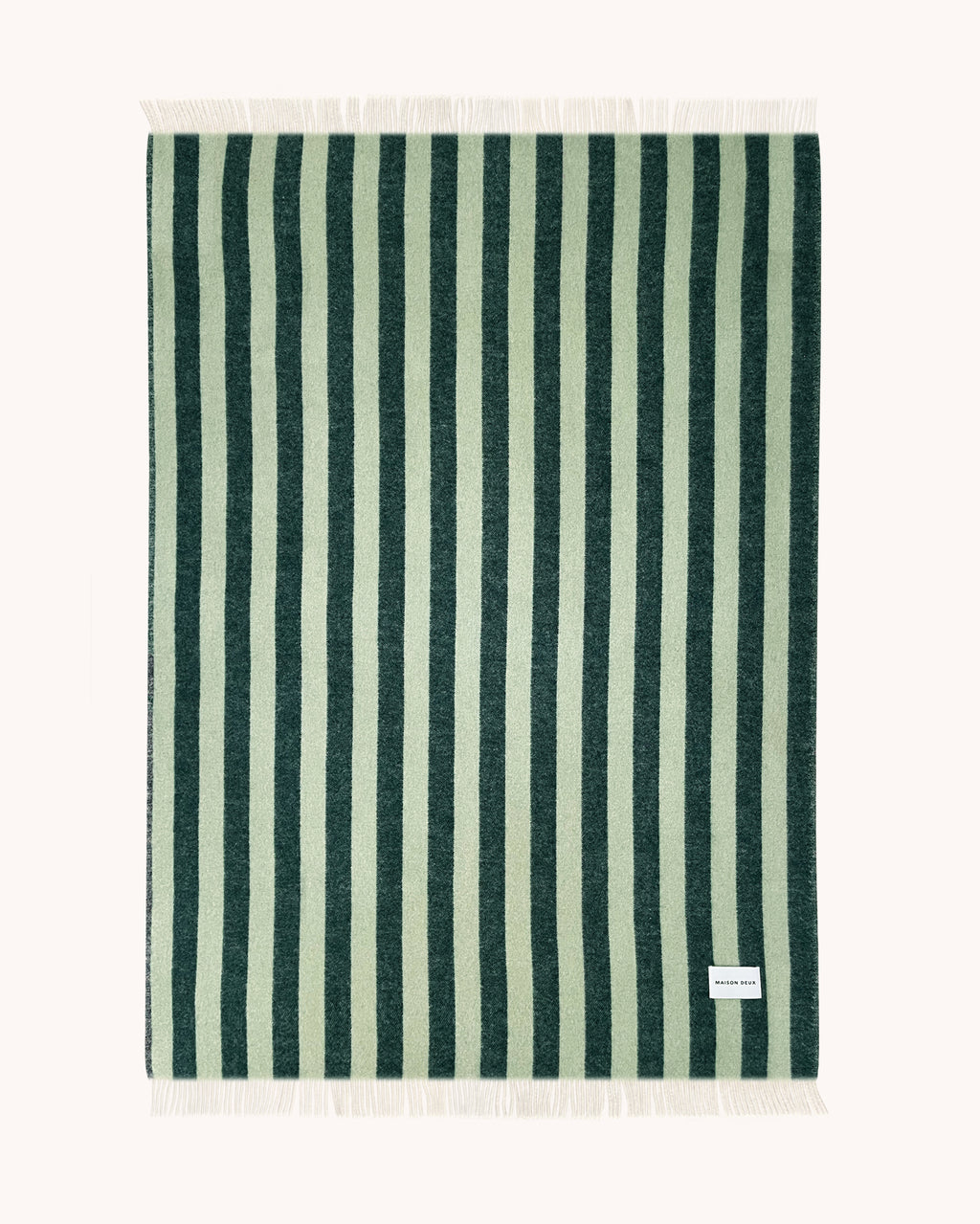 Dark green and sage striped wool throw shown flat with fringe detail
