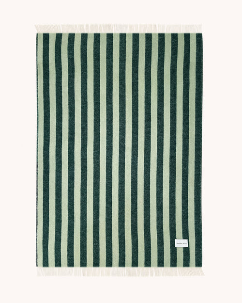 Dark green and sage striped wool throw shown flat with fringe detail

