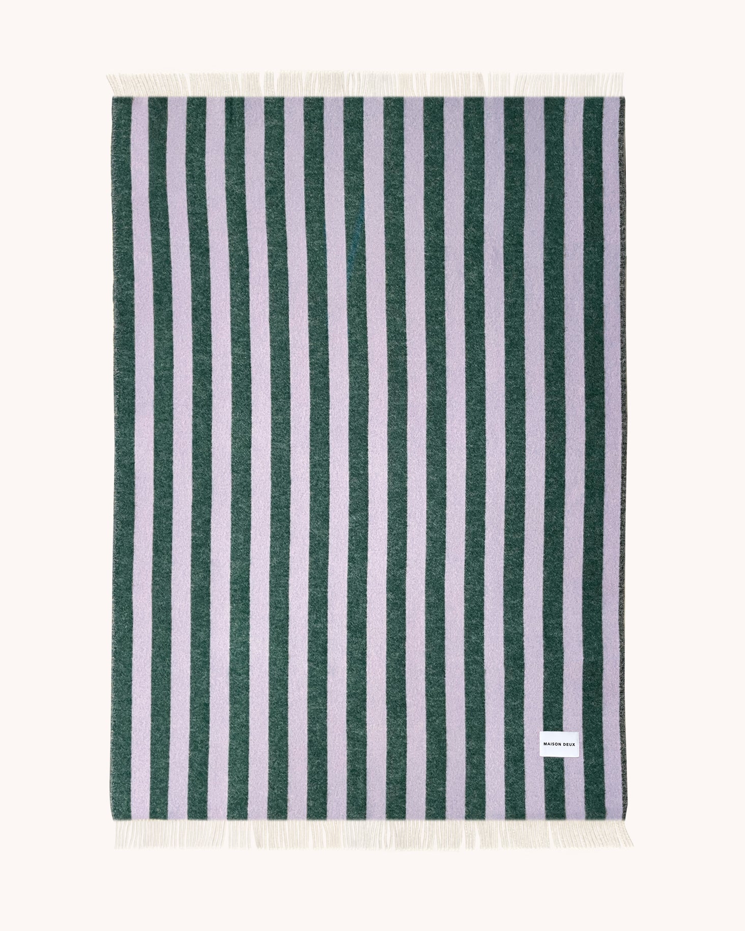Lilac and green striped wool throw shown flat
