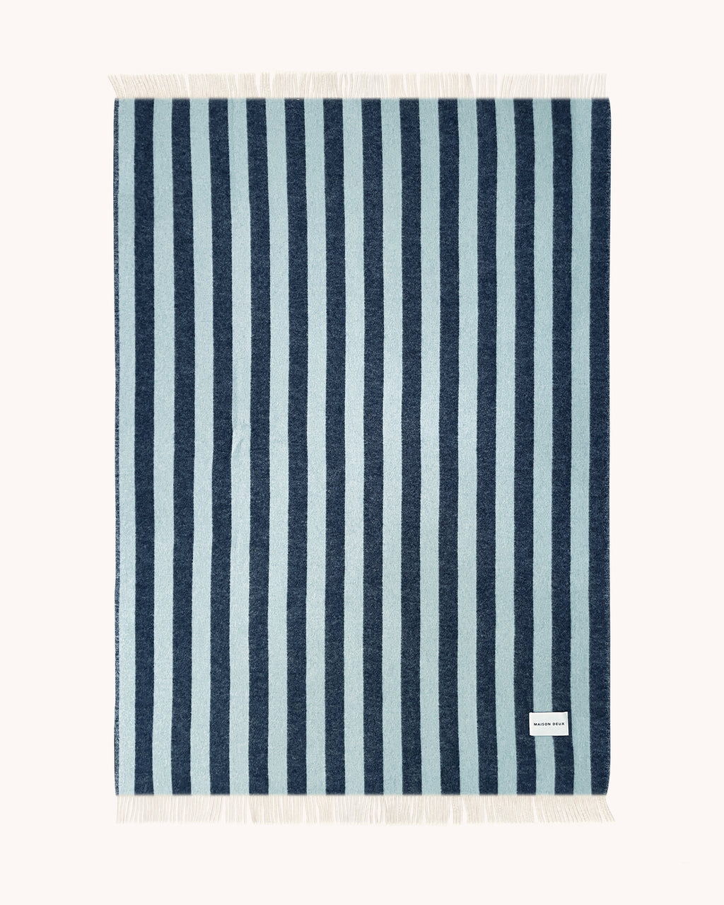 Navy and light blue striped wool throw shown flat
