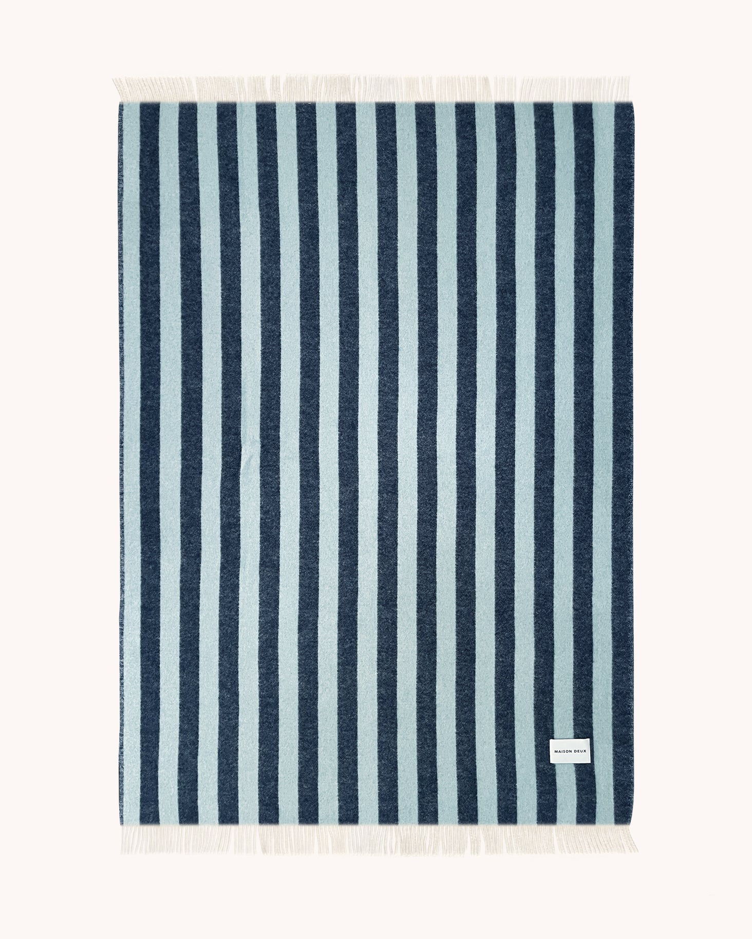 Navy and light blue striped wool throw shown flat

