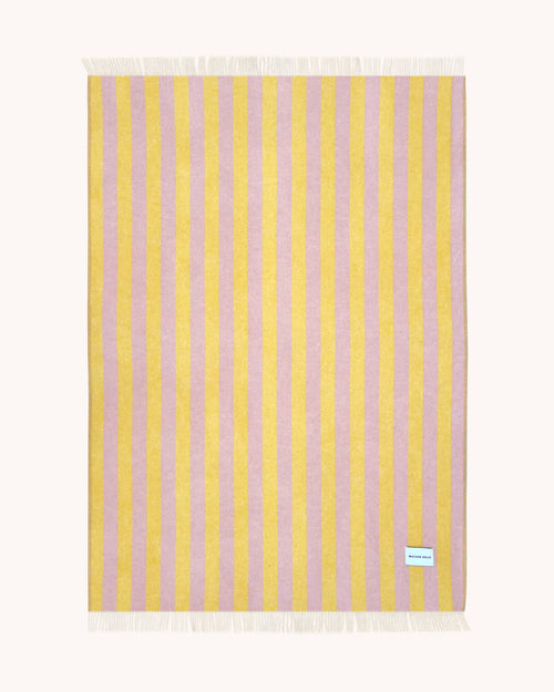 Pink and yellow striped wool throw shown flat
