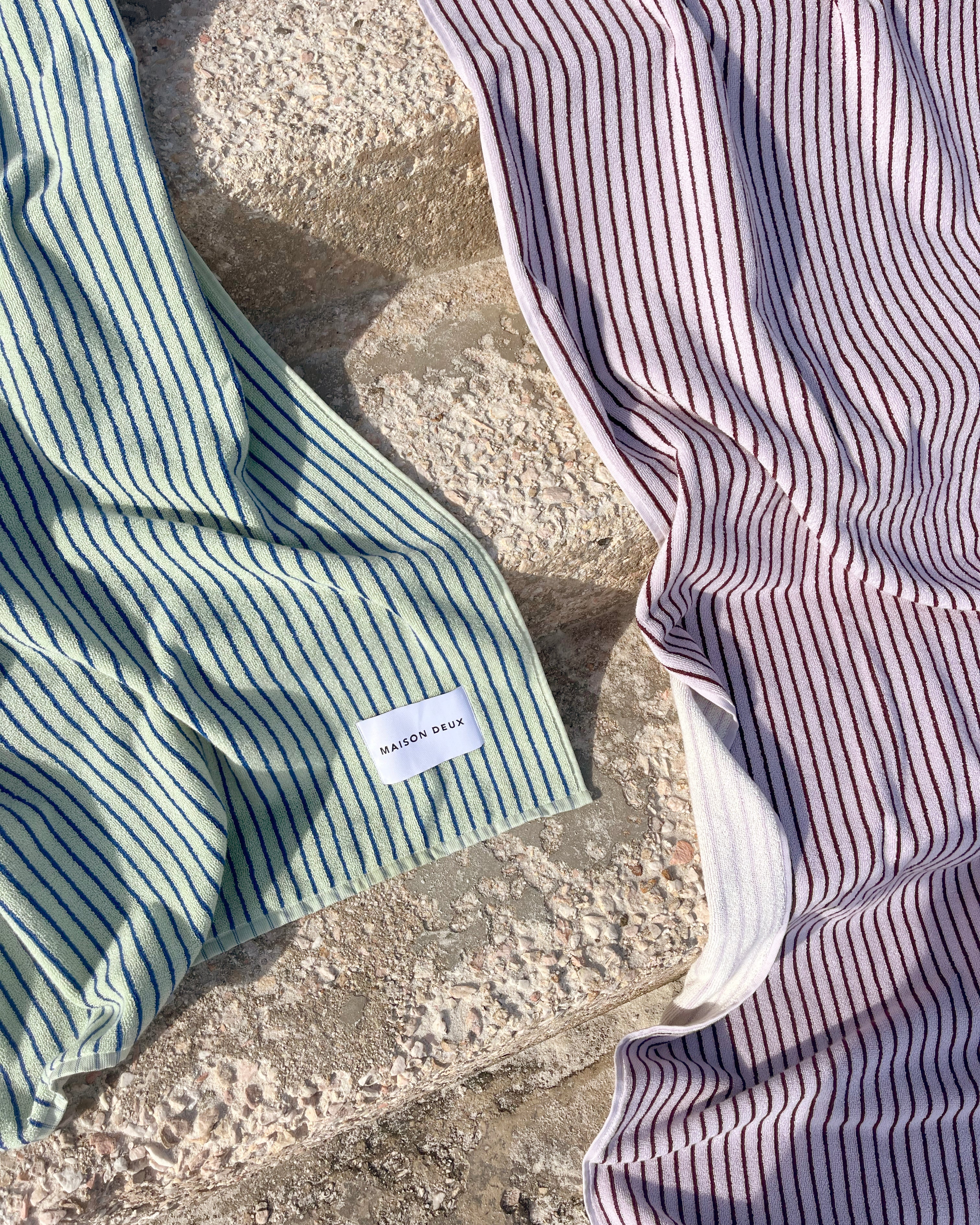 Textured 480 GSM organic cotton sage green towel styled with lilac towel