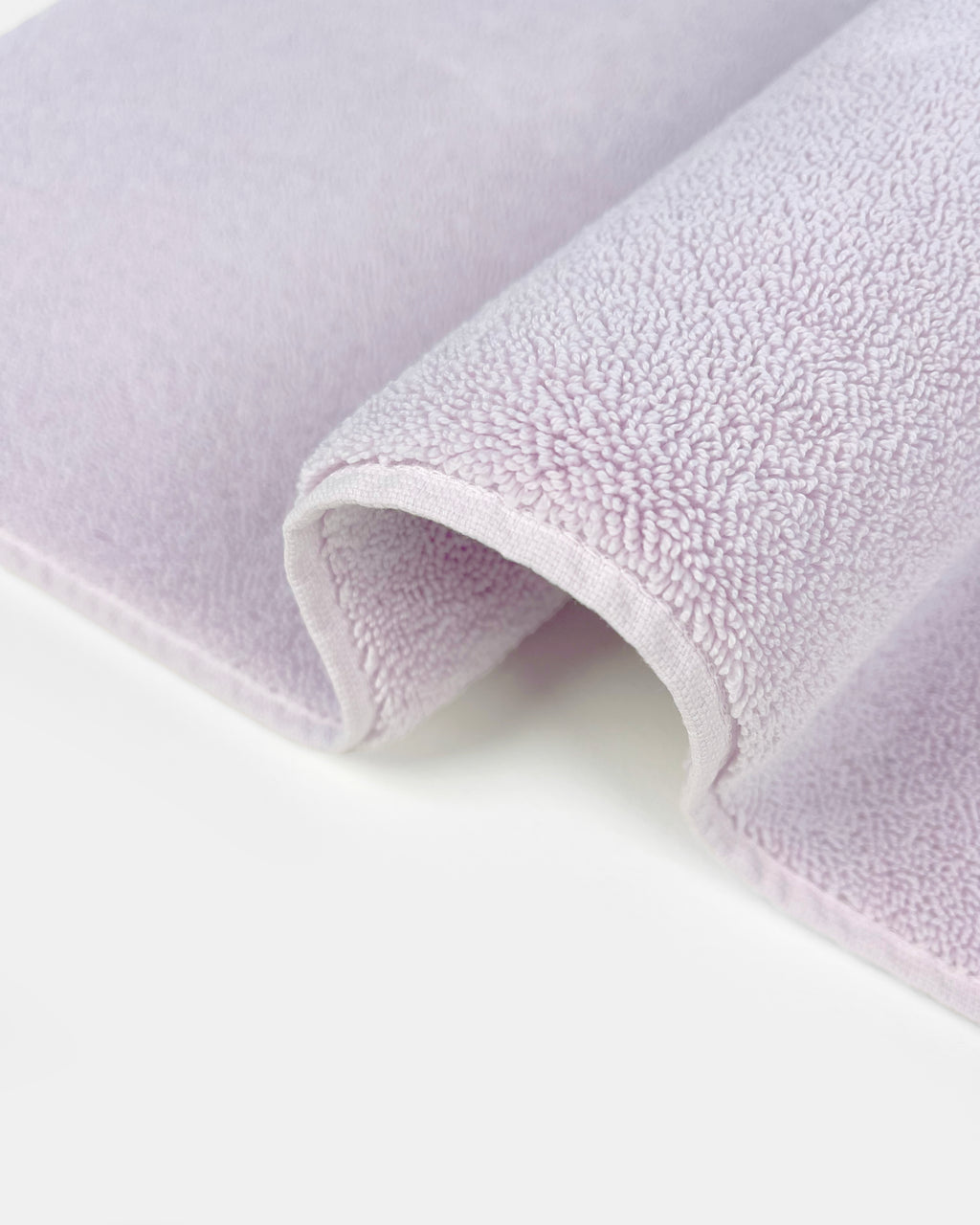 Close-up of dense GOTS-certified terry weave, lilac bath mat
