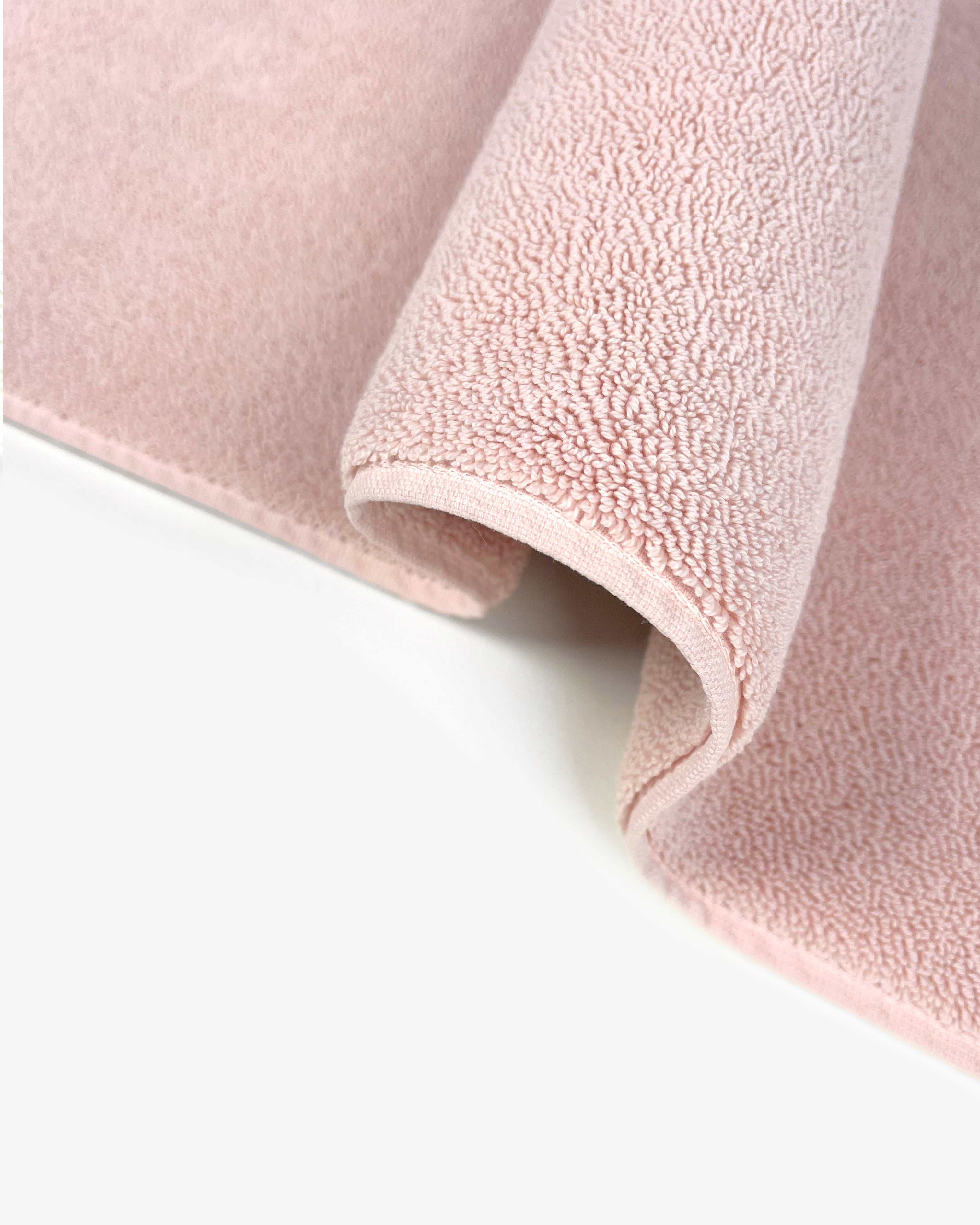 Close-up of dense GOTS-certified terry weave, pink bath mat