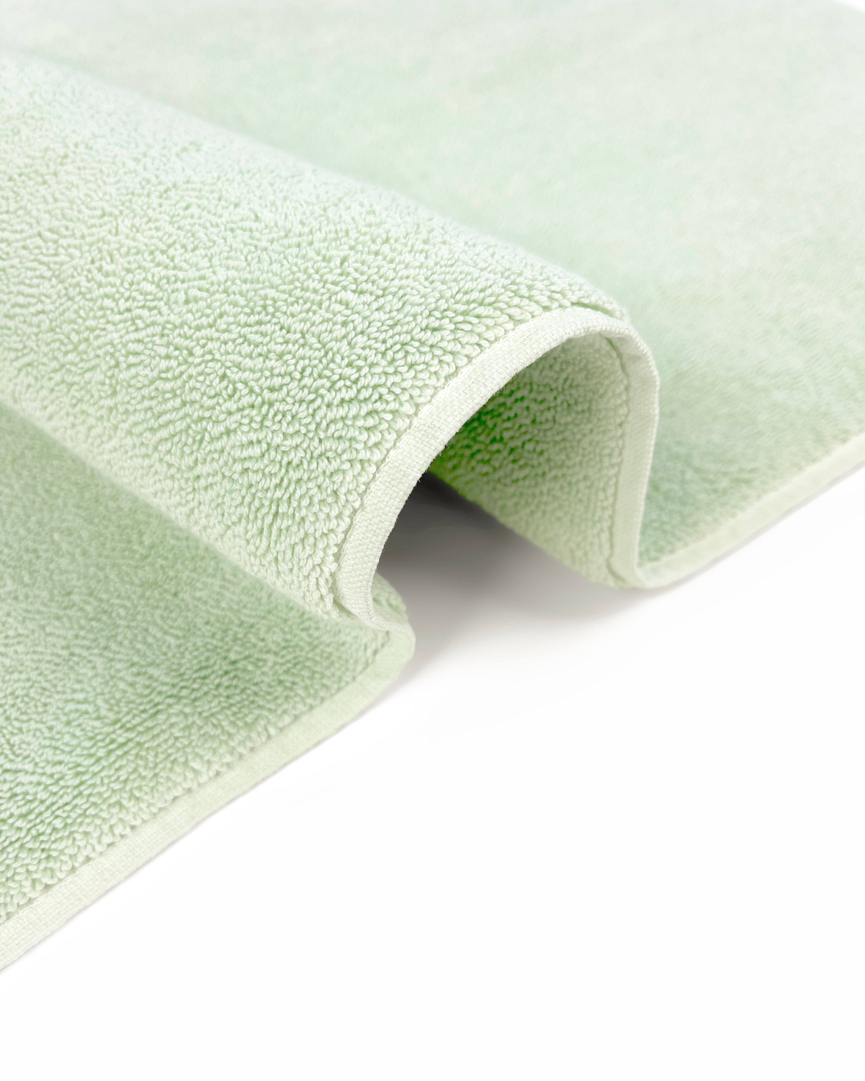 Close-up of dense GOTS-certified terry weave, sage green bath mat