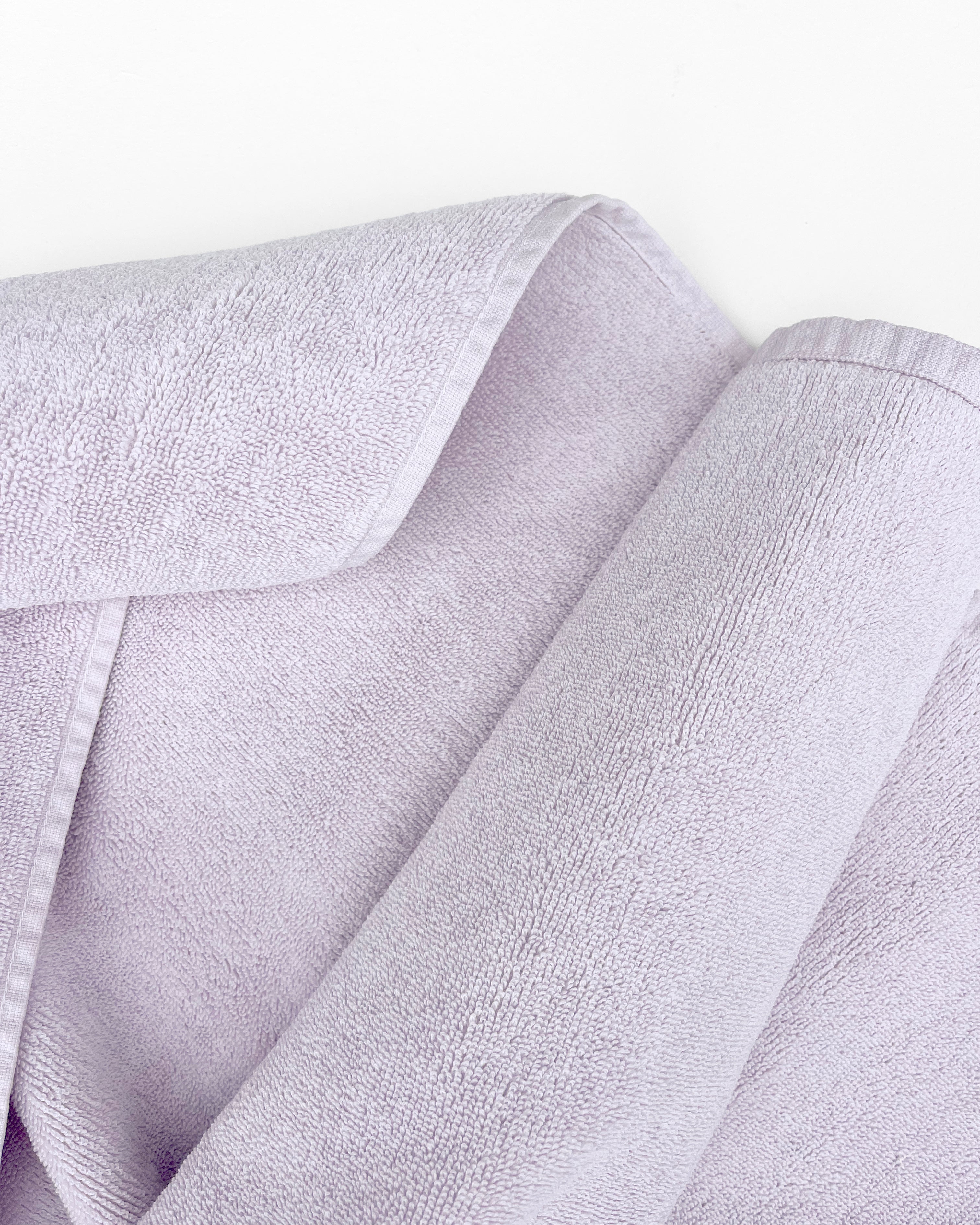 Close-up of dense GOTS-certified organic cotton terry weave, lilac