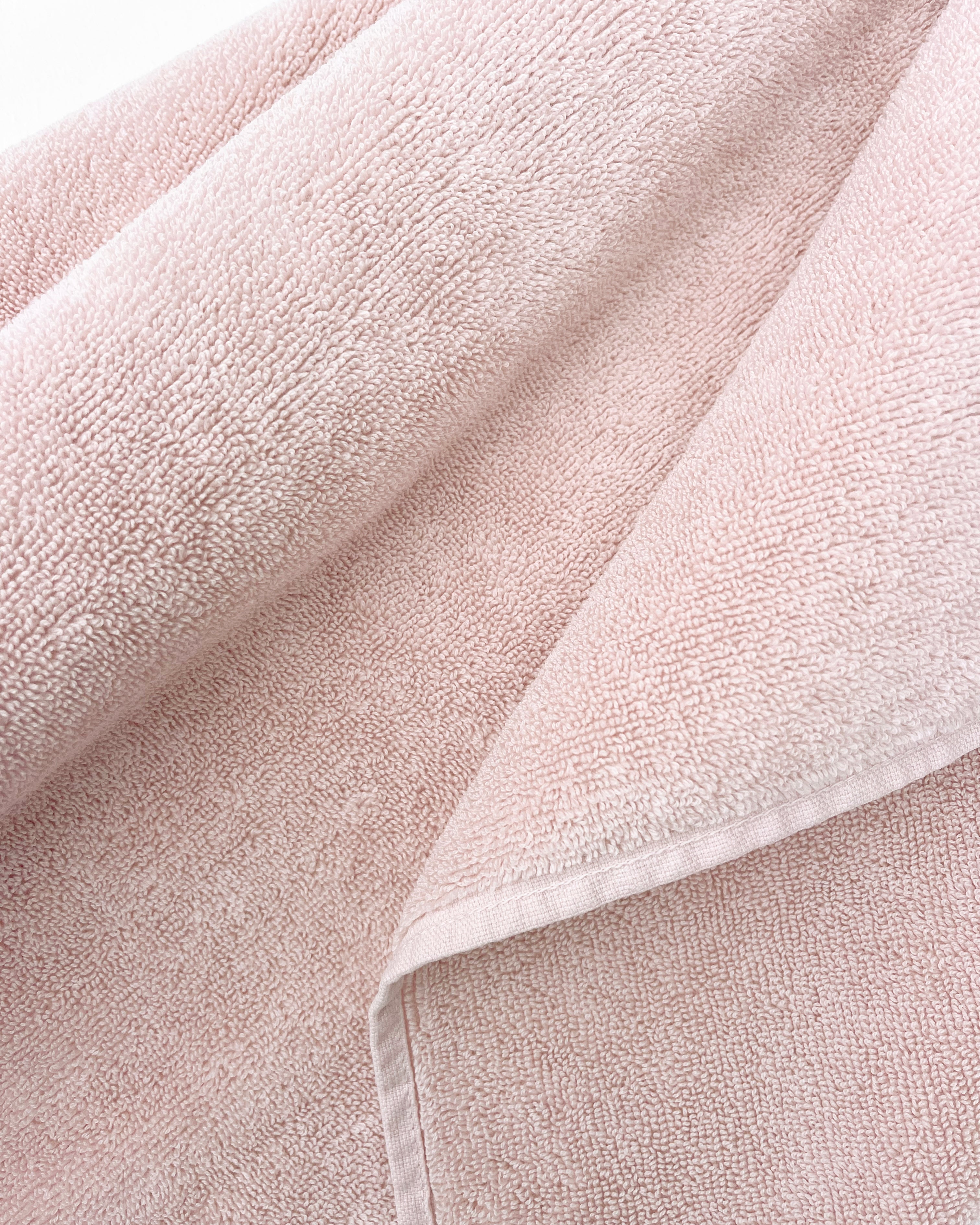 Close-up of dense terry weave on solid pink towel