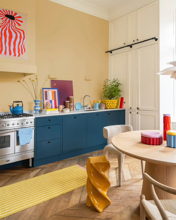Mustard yellow and cream striped rug styled as kitchen runner