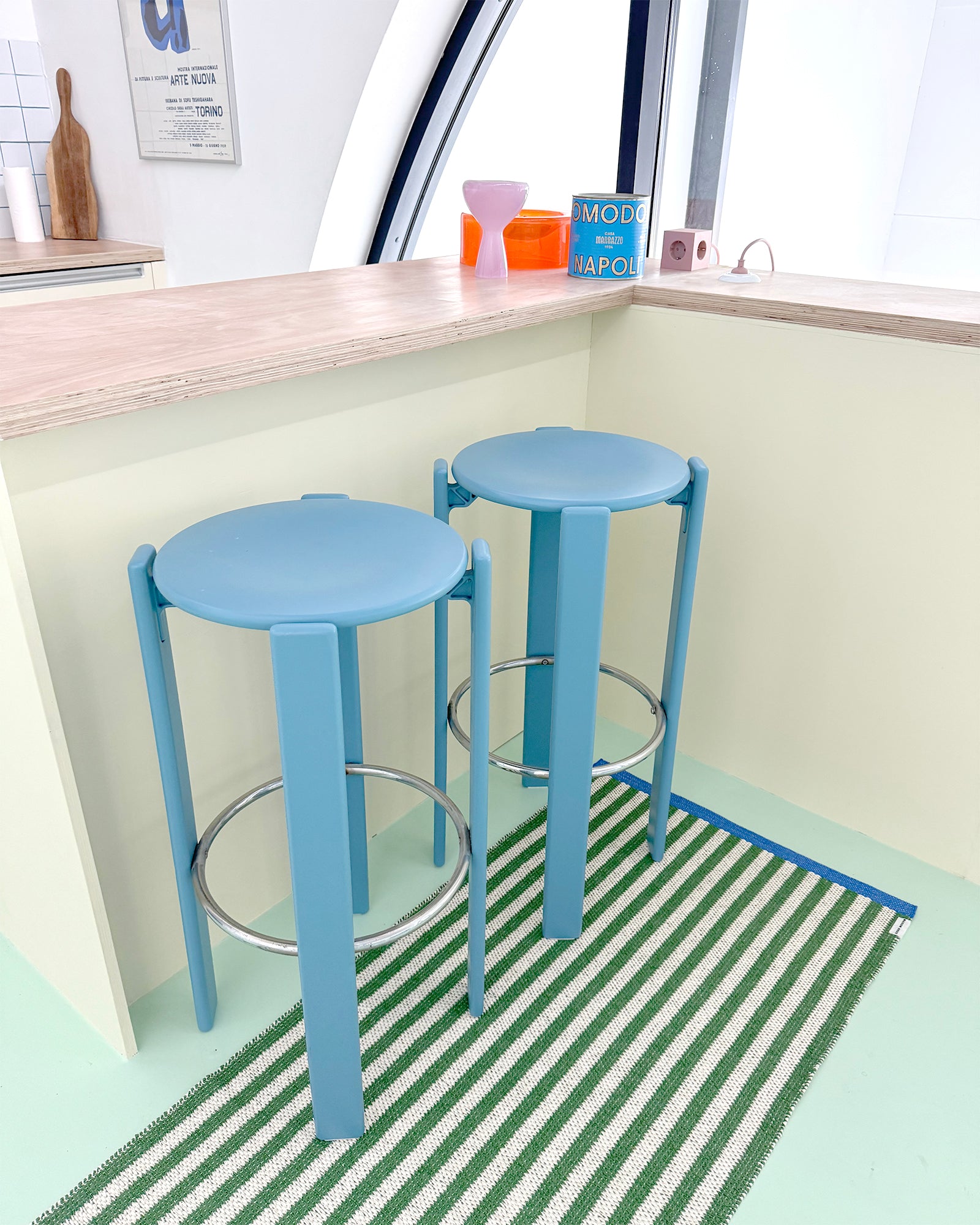 Green and white striped rug styled as kitchen runner