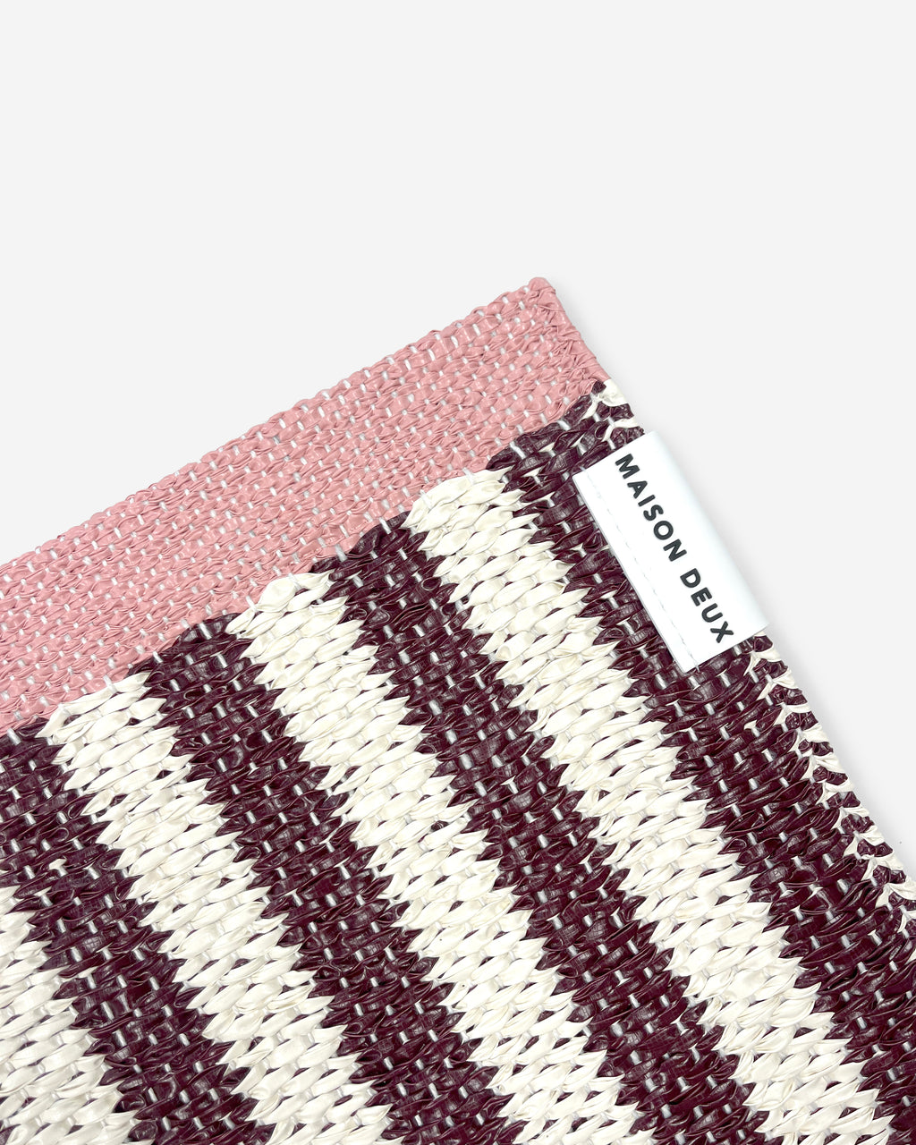 Close-up of Swedish woven jacquard stripe pattern, dark red and cream with pink border