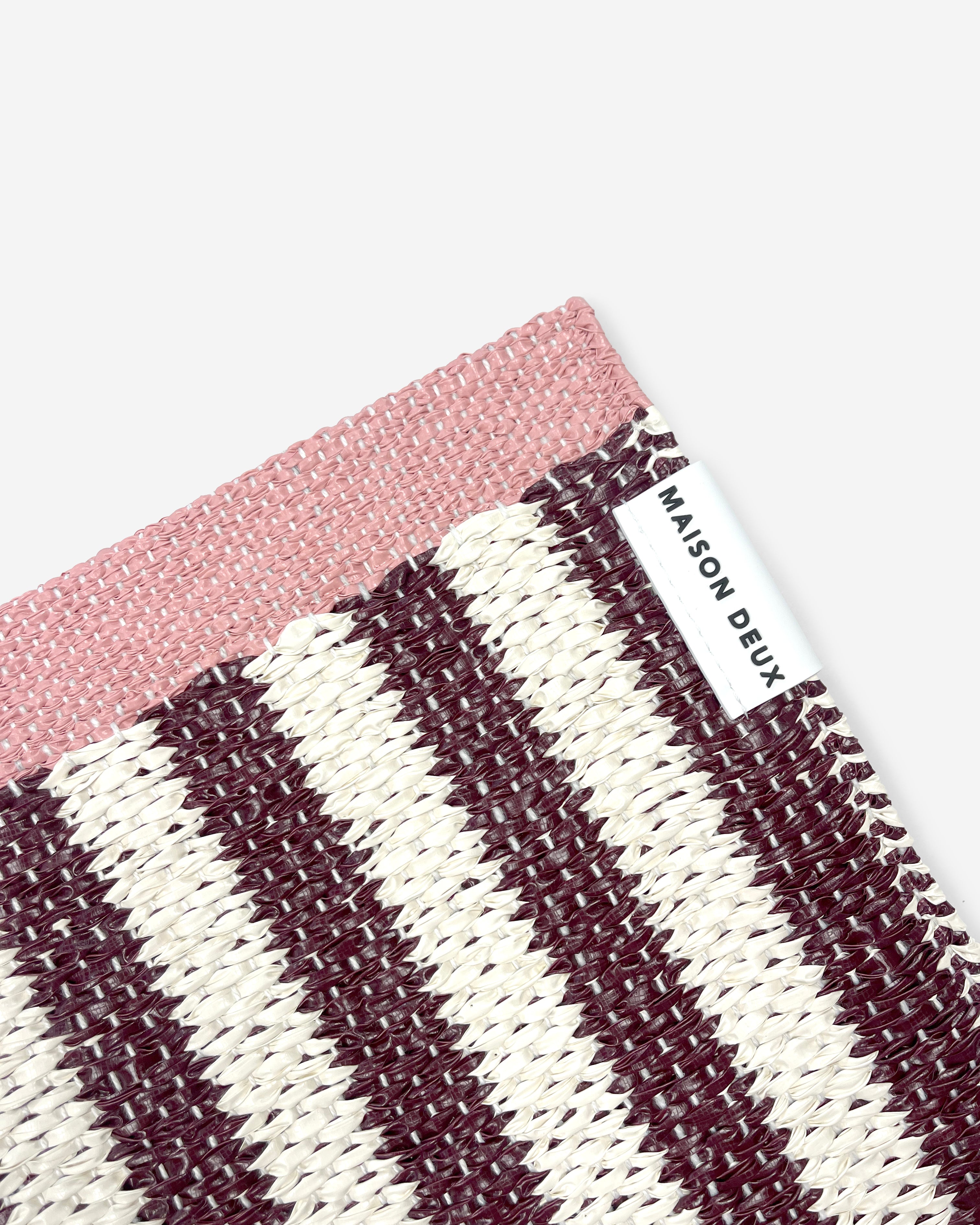 Close-up of Swedish woven jacquard stripe pattern, dark red and cream with pink border
