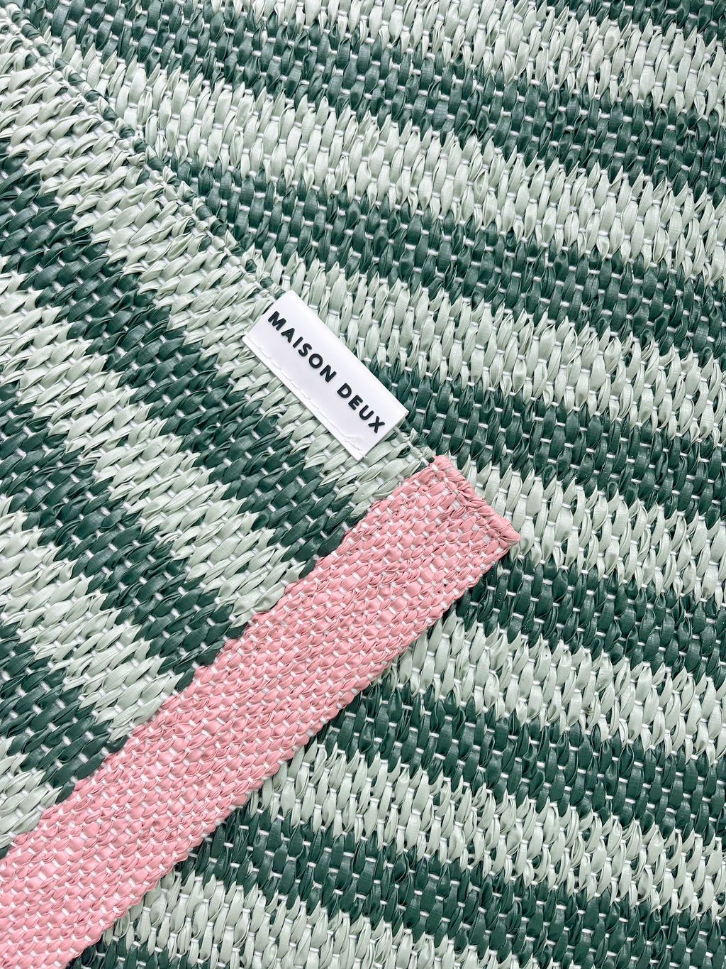 Close-up of Swedish woven jacquard stripe pattern, green and light green with pink border