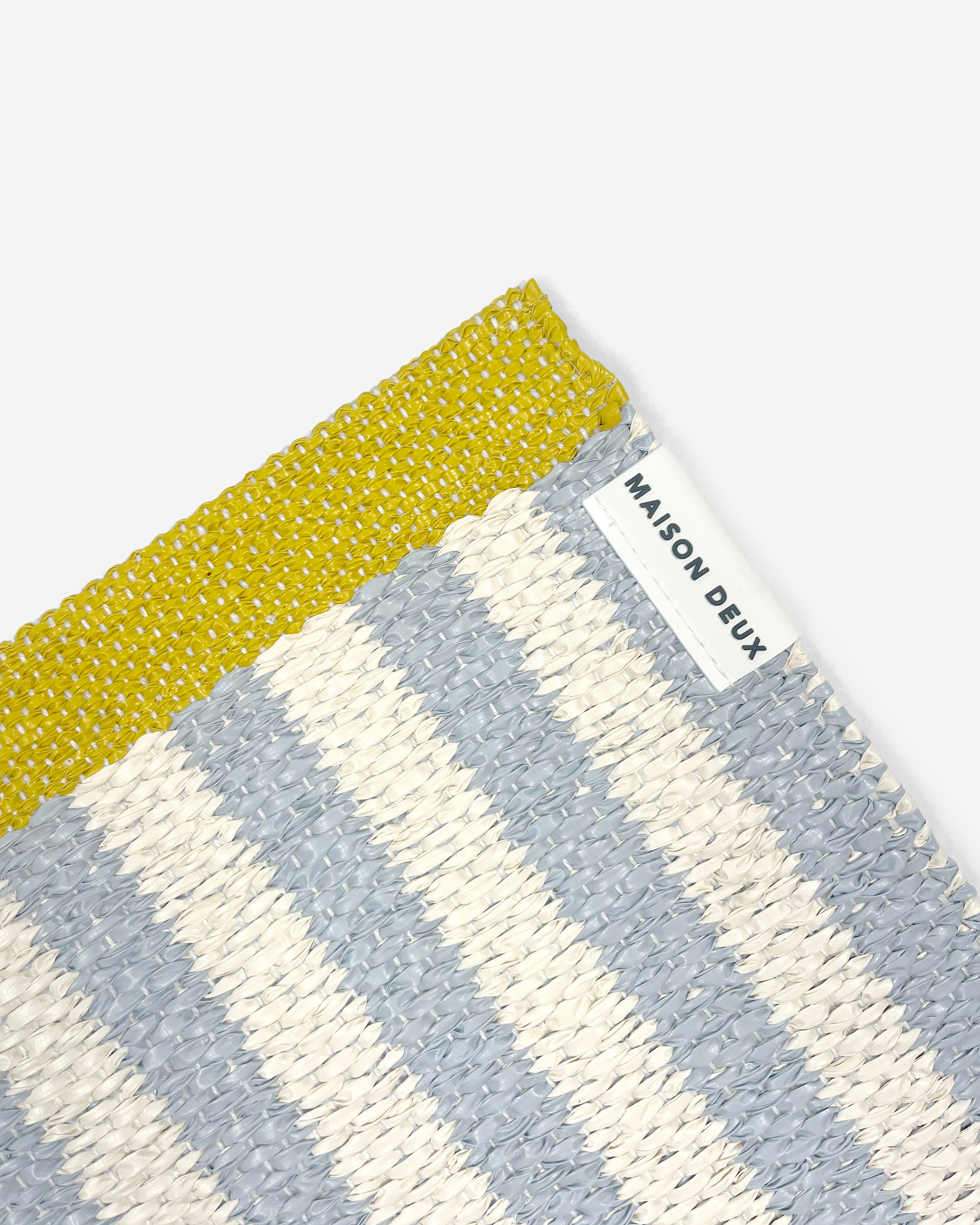 Close-up of Swedish woven jacquard stripe pattern, sky blue and white with mustard border