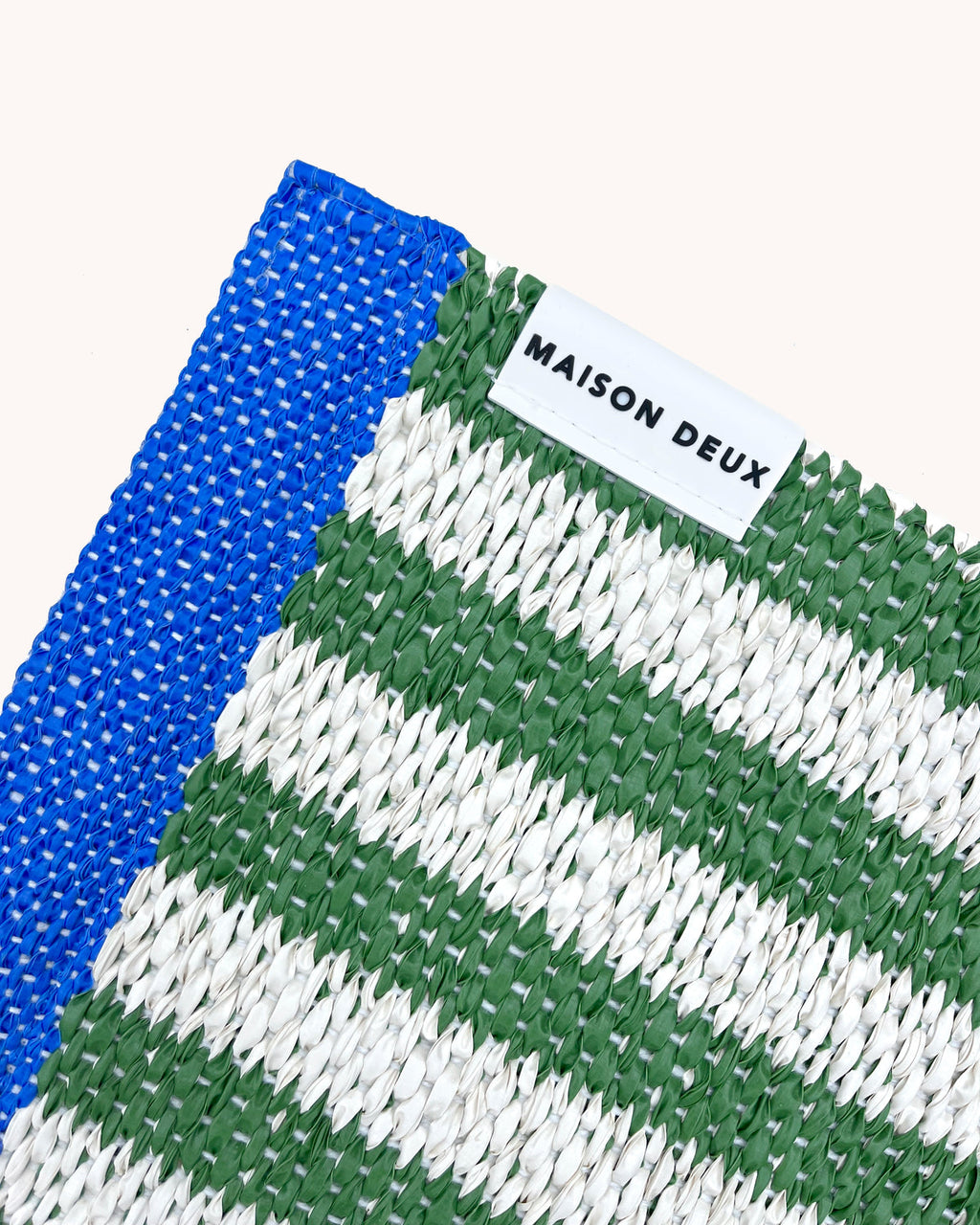 Close-up of Swedish woven jacquard stripe pattern, white and green with blue border