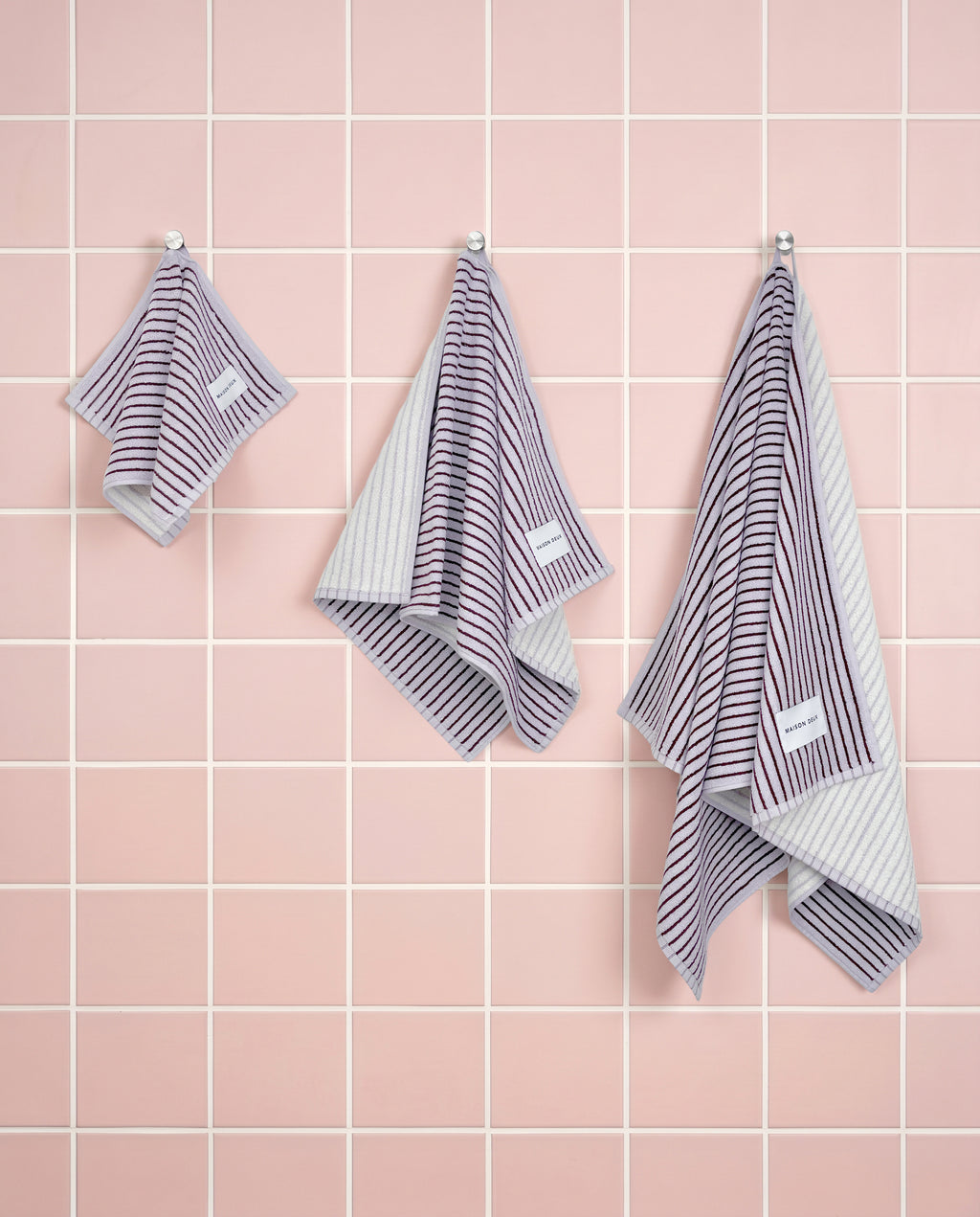 Lilac bordo striped organic cotton towels shown in guest, hand and bath sizes