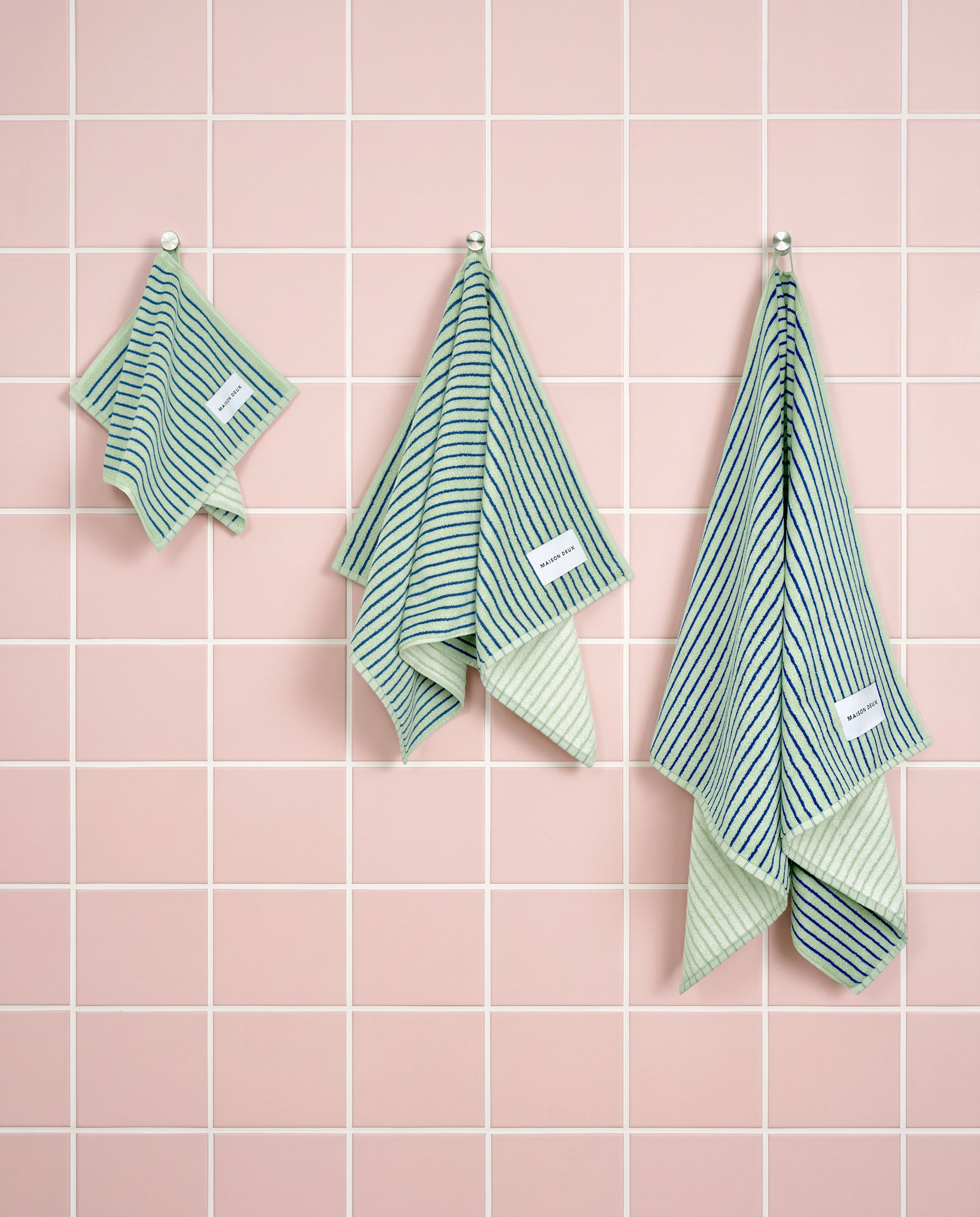 Sage cobalt blue striped organic cotton towels shown in guest, hand and bath sizes