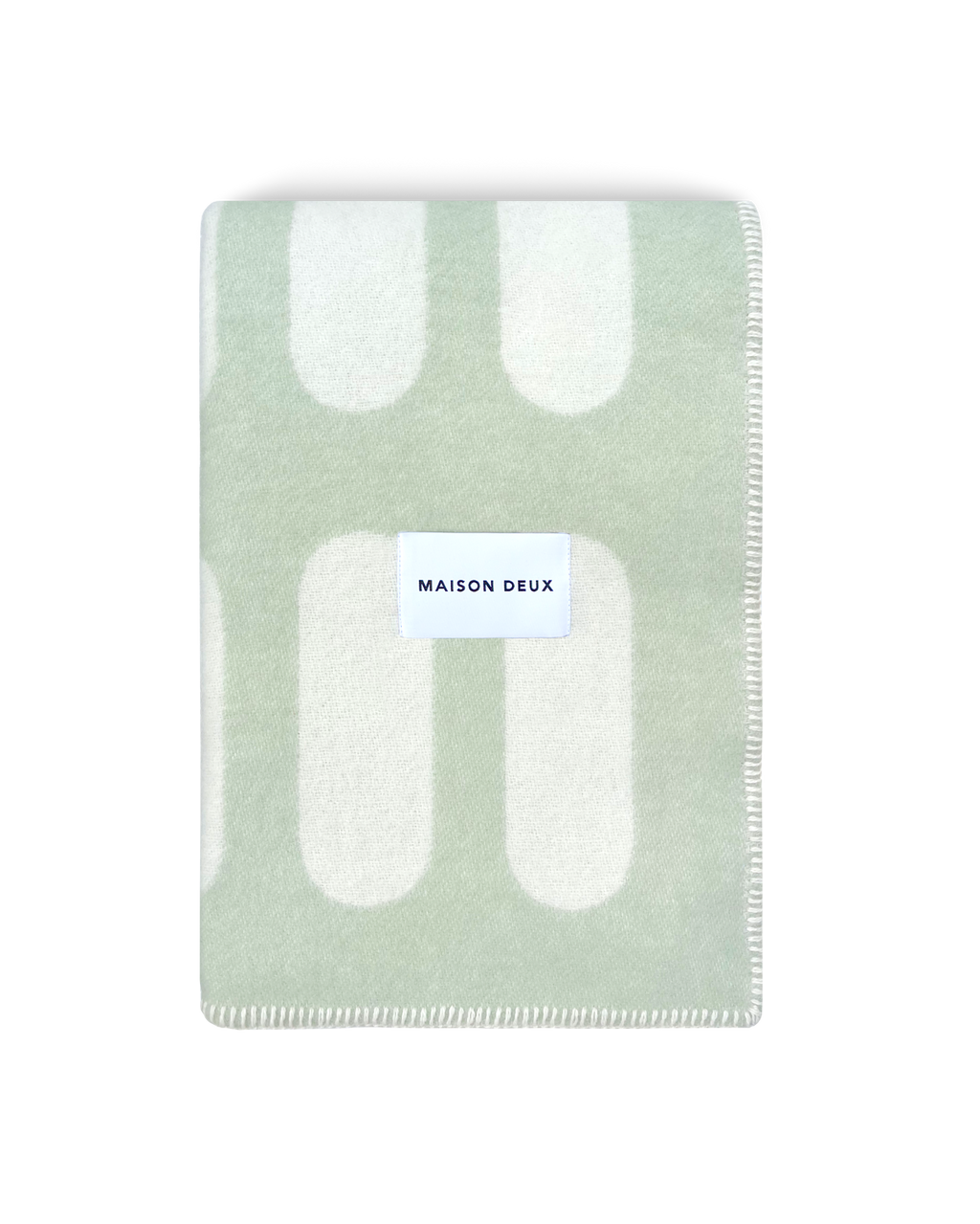 Chill Pill sage green wool throw blanket with plaid pattern and Maison Deux label