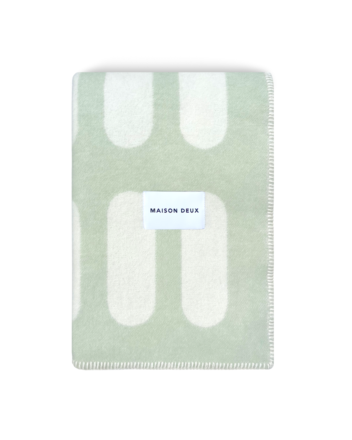 Chill Pill sage green wool throw blanket with plaid pattern and Maison Deux label